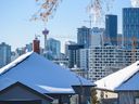 The Calgary skyline is seen from behind some houses in Bridgeland.