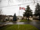 A Canadian flag in front of homes in a Toronto neighbourhood. The Bank of Canada's latest rate hike will inflict more pain on homeowners.
