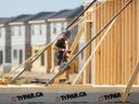 A construction worker framing a new house in London, Ont.